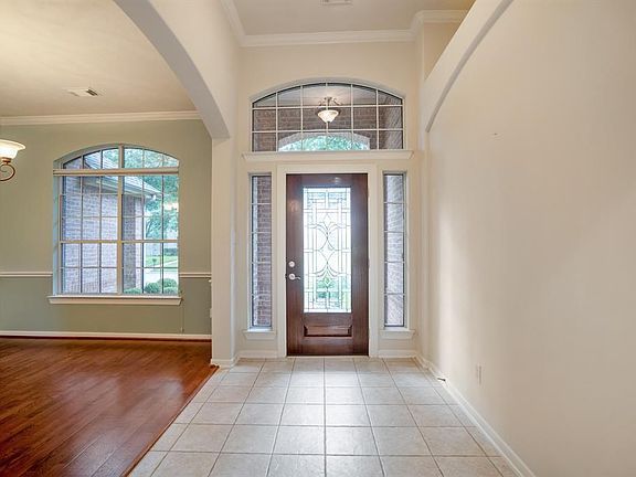 The windows in this home WOW! The natural light enters the space through the picture windows, arched windows, sidelights and this amazing leaded glass front door!