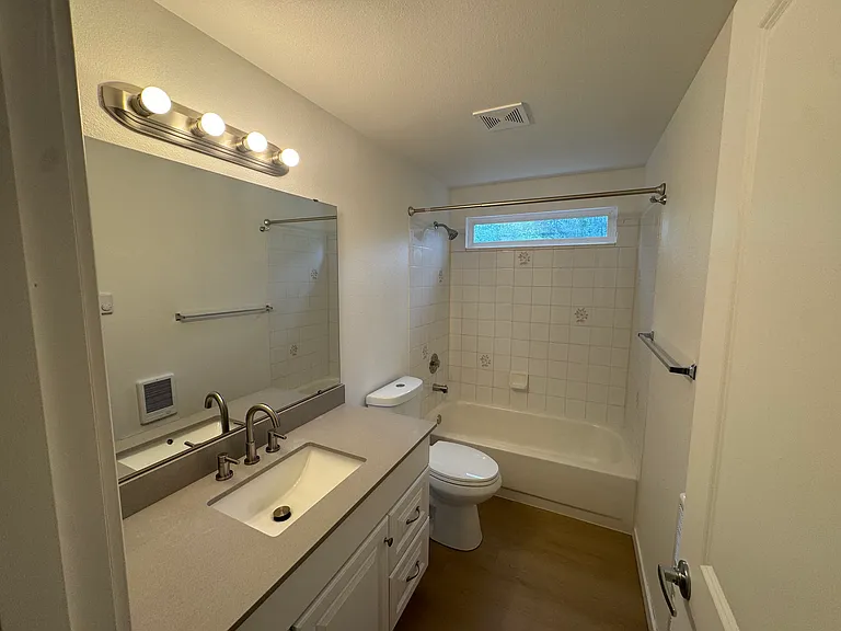 Private primary bathroom featuring a full-size vanity, tub/shower combination, and bright, functional design.
