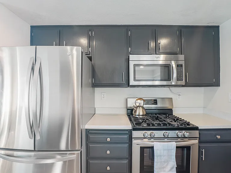 Enjoy cooking in the upgraded kitchen, complete with sleek granite countertops and a full suite of stainless steel appliances, including a refrigerator, range, microwave, and dishwasher.