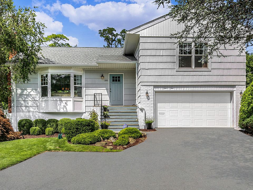 On an enviable corner lot, boasting a rare double cul de sac and hedge-trimmed privacy!