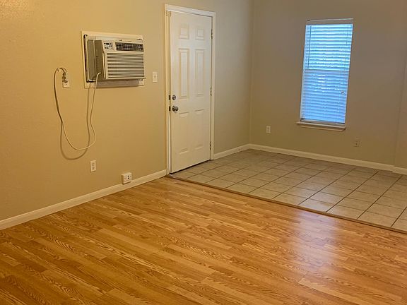 Efficiency with hardwood floors in living area and tile floor in eating nook and kitchen