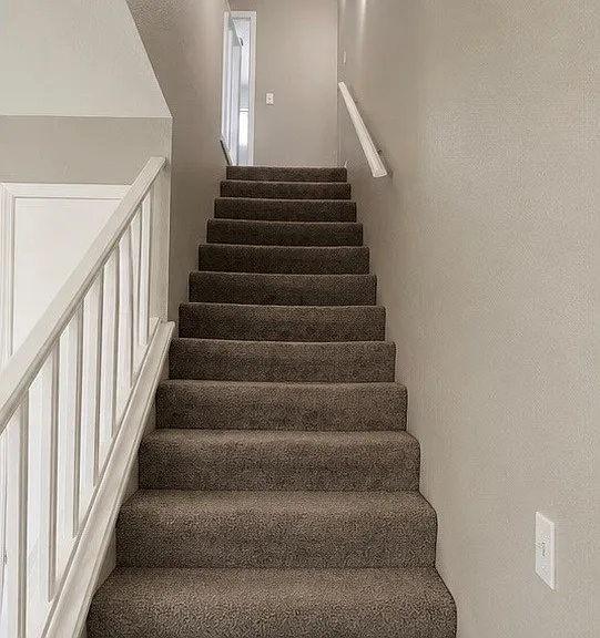 Staircase leads to the second floor, where you'll find two bedrooms and a full bathroom.