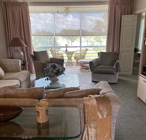 View from dining room through condo to lanai. Folding doors to den/guest bedroom is shown on right.
