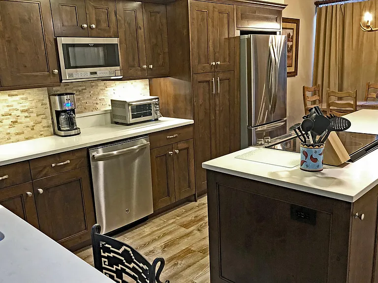 In the center of the photo left of the refrigerator is a large pantry with pull out shelves.