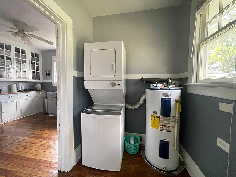 New stacked washer and dryer (June 2023) inside home.