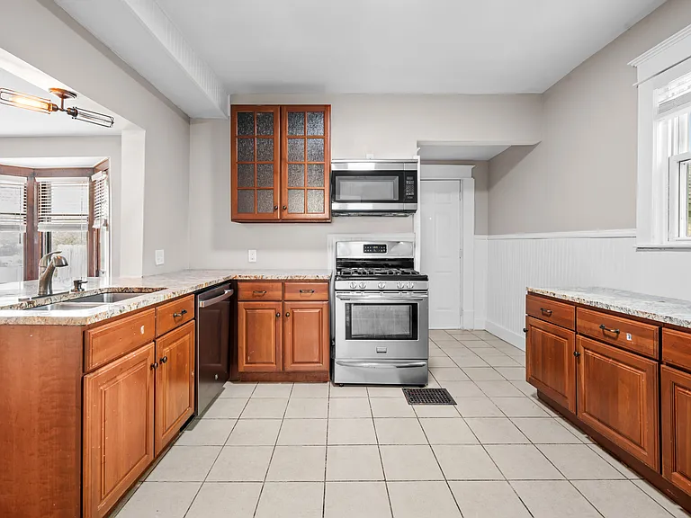 kitchen has stainless steel appliances and granite countertops