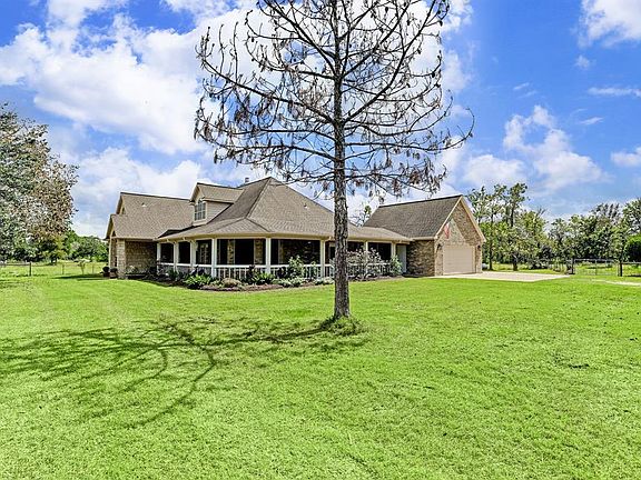 One story home on acreage with wrap around porch, side garage with attic space and circular drive.