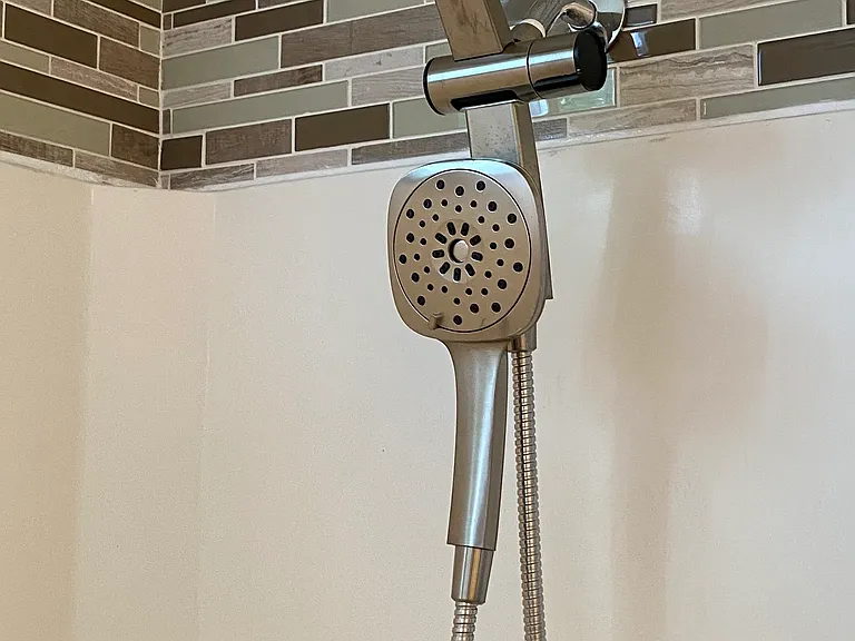 Shower backsplash and brushed nickel multi-function shower heads