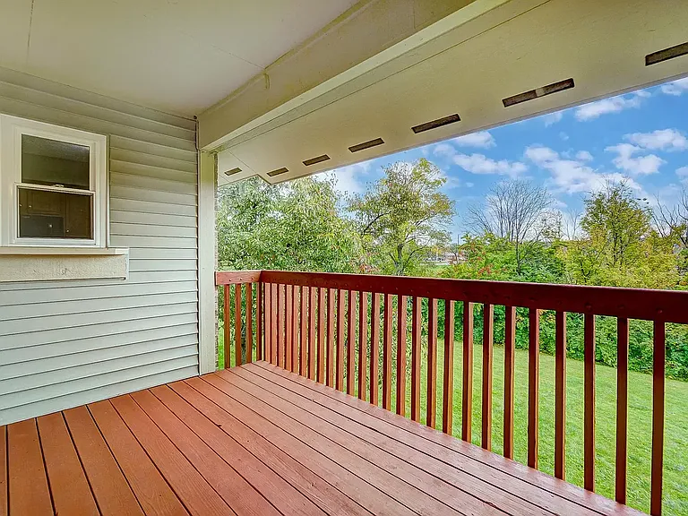 Balcony overlooking greenery and creek