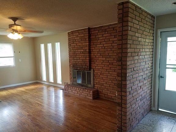 front entry with beautiful brick wall divider