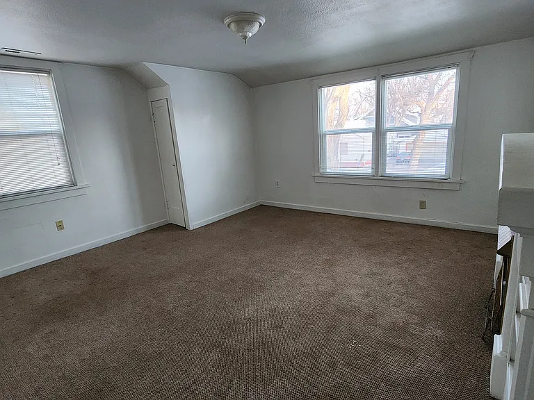 Livingroom is carpeted with 2 closets and windows on north and west sides.