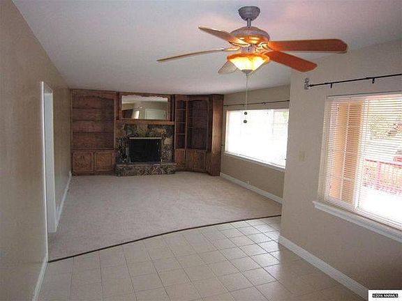 Dining flows to Living with built-ins, large window to prett