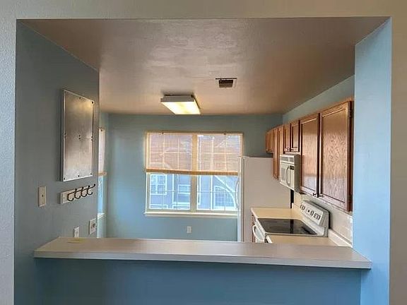 Bar-height counter with view into eat-in kitchen. Perfect for extra seating.