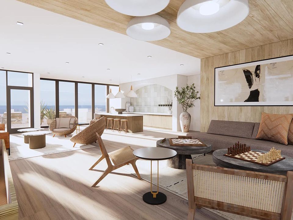 Sky lounge with ocean views, comfortable seating, and outdoor terrace at Modera Revere Beach apartments near Boston.