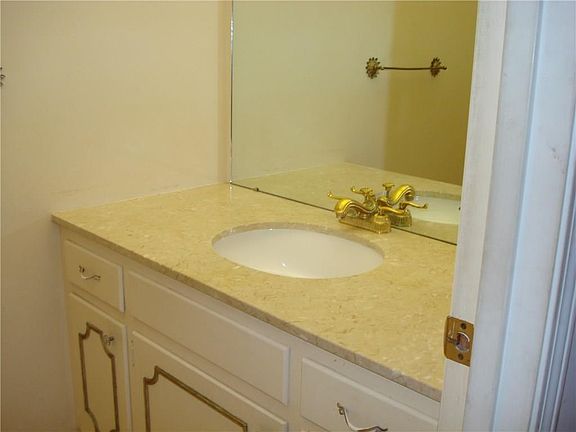 Half bath located off the hallway near the family room and the living room.