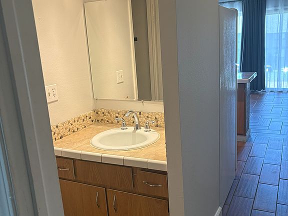 Bathroom with tub and shower, lots of space for your things.