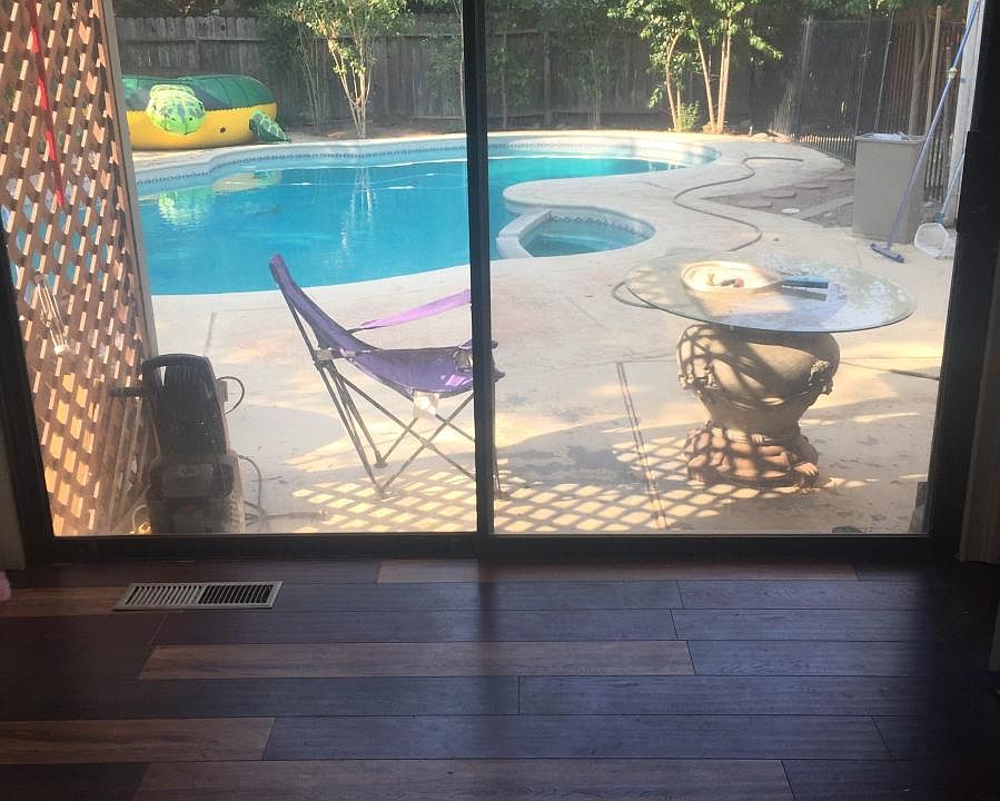 Downstairs bedroom with patio door to pool
