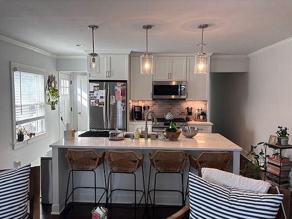 Additional view of kitchen showcasing current tenants' decor.