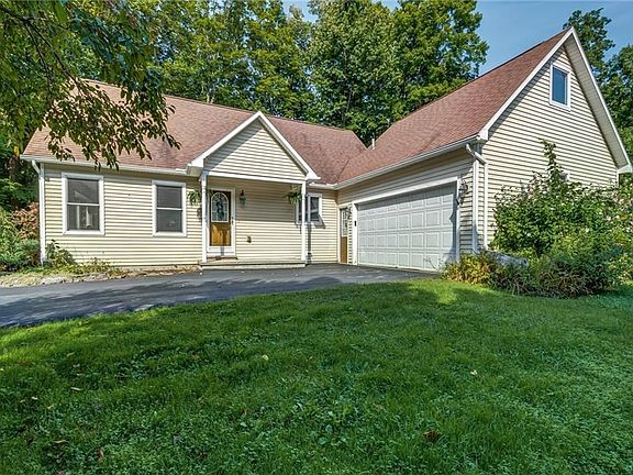 The 2 car attached garage has a staircase leading up to a large storage room
