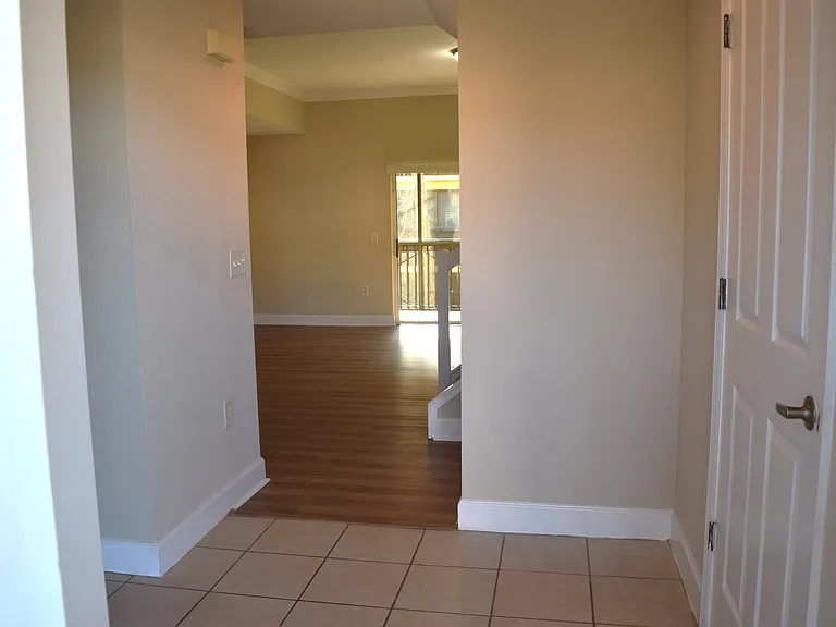 Welcoming foyer with kitchen to the left and half bath to the right.