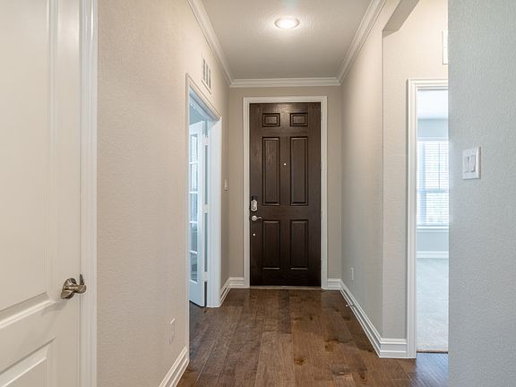 Welcoming entryway with wood flooring.