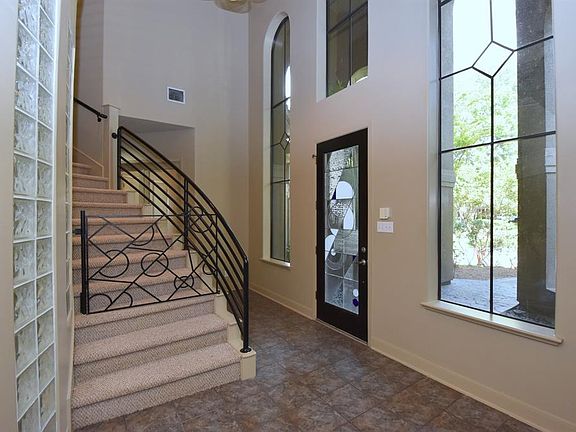 The front door opens to wide arced foyer, and is lighted by two story windows, making it light and bright.
