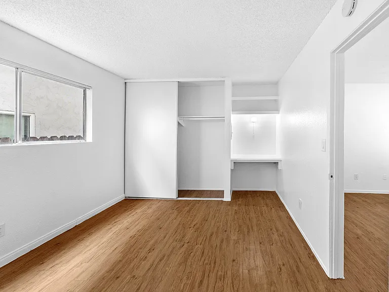 Bedroom with closet and computer desk area