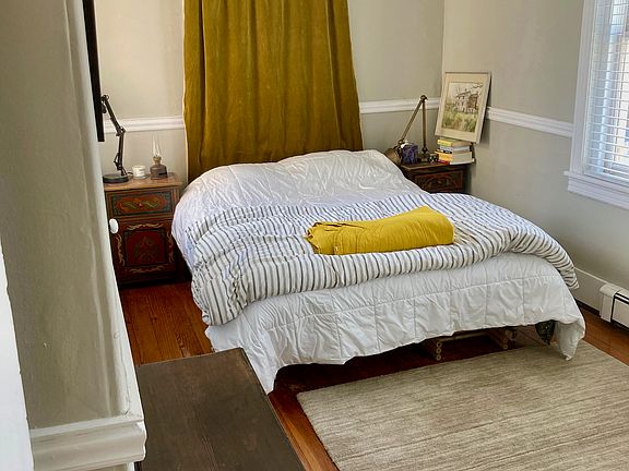 Bedroom with attached deck overlooking private patio and canal