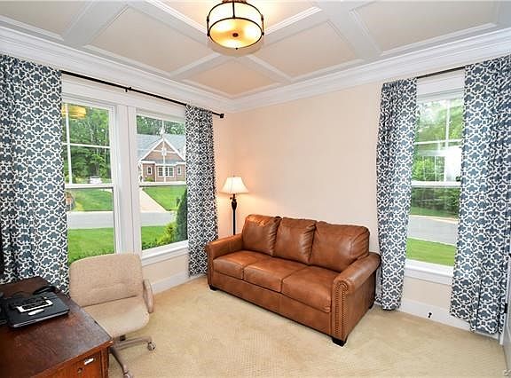 The Office features carpet, crown moulding coffered ceiling, french doors and a closet