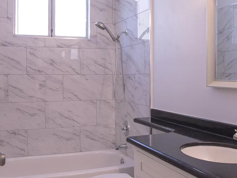 Full bathroom downstairs right with newly renovated shower and new cabinets and toilet