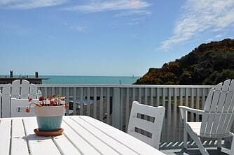 large roof top deck with amazing views of ocean and hillside