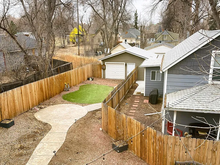 Large backyard with stamped concrete patios and walkway, bistro lights, full xeriscape and fully fenced. 2 car garage available with additional rent.