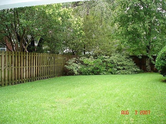 Lovely landscaped backyard with privacy fence