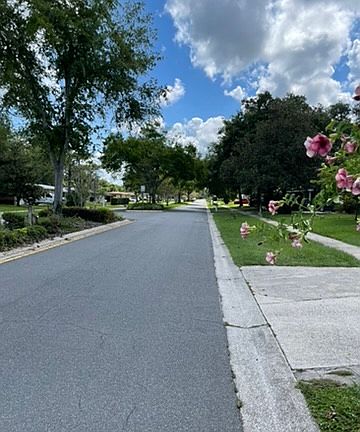 Quiet neighborhood, road divided by beautiful Landscaping