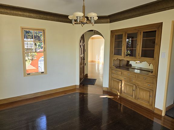 Dining room has built in cabinets and vintage fixtures.