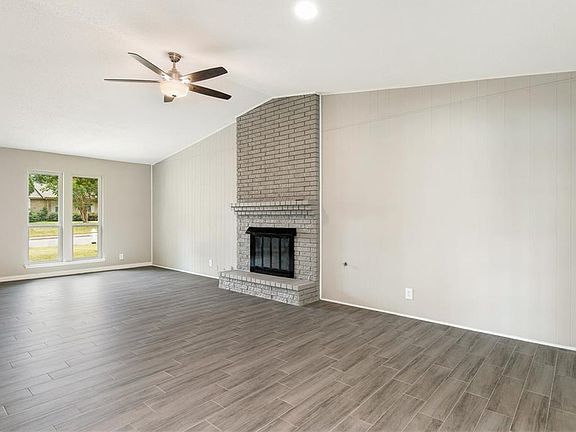 Spacious living area with a beautiful fireplace and loads of natural light