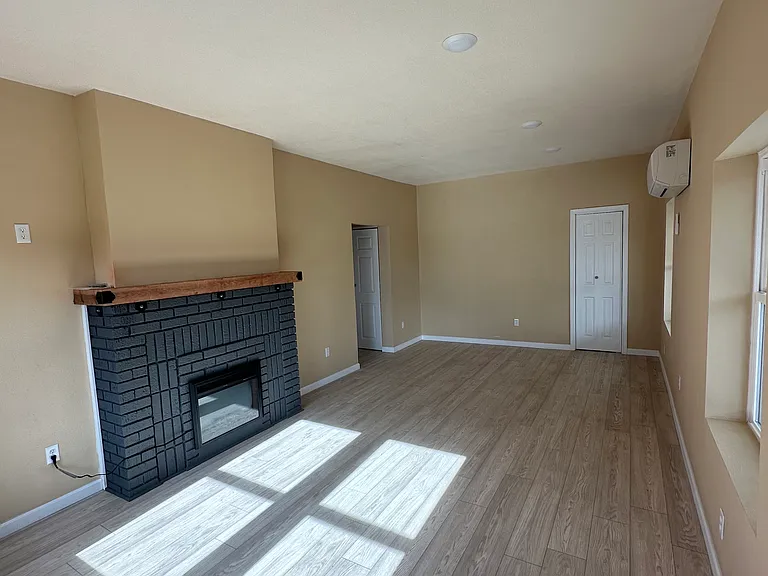 Looking from the balcony to the hall. This unit has a coat closet in the living room on the far wall. Down the hall there is an additional on the left and a pantry closet . On the right is the stackable washer dryer closet.