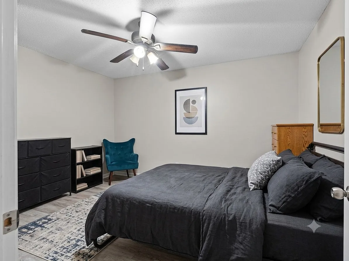 Spacious primary bedroom with neutral finishes, abundant natural light, and plenty of room for a king-size bed and additional furnishings.