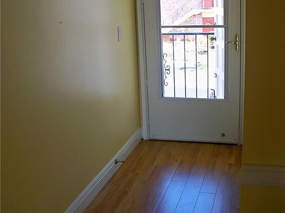 Foyer with laminate flooring, screened entry door
