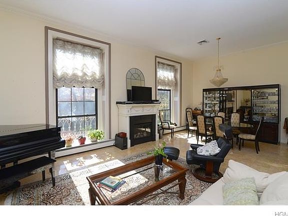 Living Room/Dining Room with 14' Ceilings and Gleaming Marble flooring