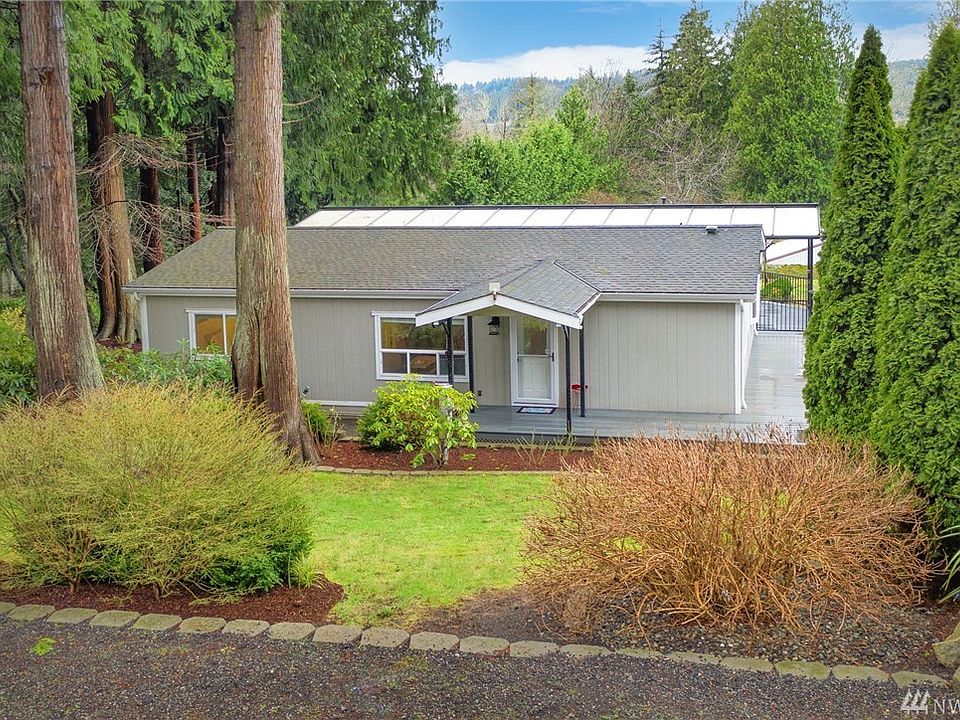 Tucked off the road on nearly half an acre. Unassuming from the front, but keep looking! That Hydrangea on the right - WOW! Look at the later photos.