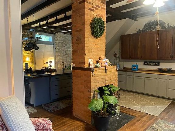 Decorative Old Original Fireplace -NOTE: Not Working. Great for Battery Operated Candles and Ambiance. Cabinets in Background Lots of counterspace and storage