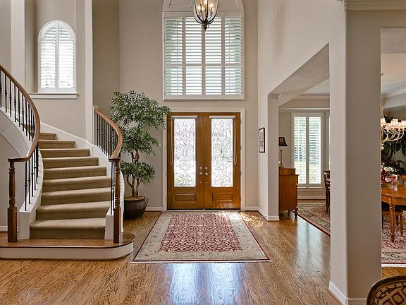  Two Story entry with hardwood flooring and sweeping staircase