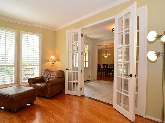 Second view of the study highlights the beautiful French doors leading back out to the foyer!