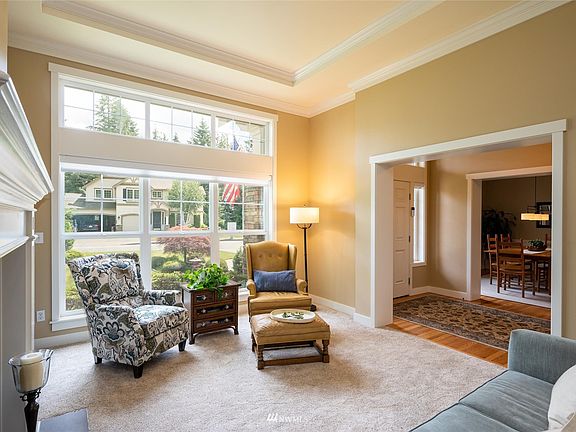 Main entry on the right between this cozy living room with gas fireplace and dining room that can fit the largest of tables!>