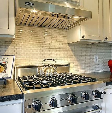 Gas Viking cooktop and hood.  Unique 1X2 subway tiled backsplash.