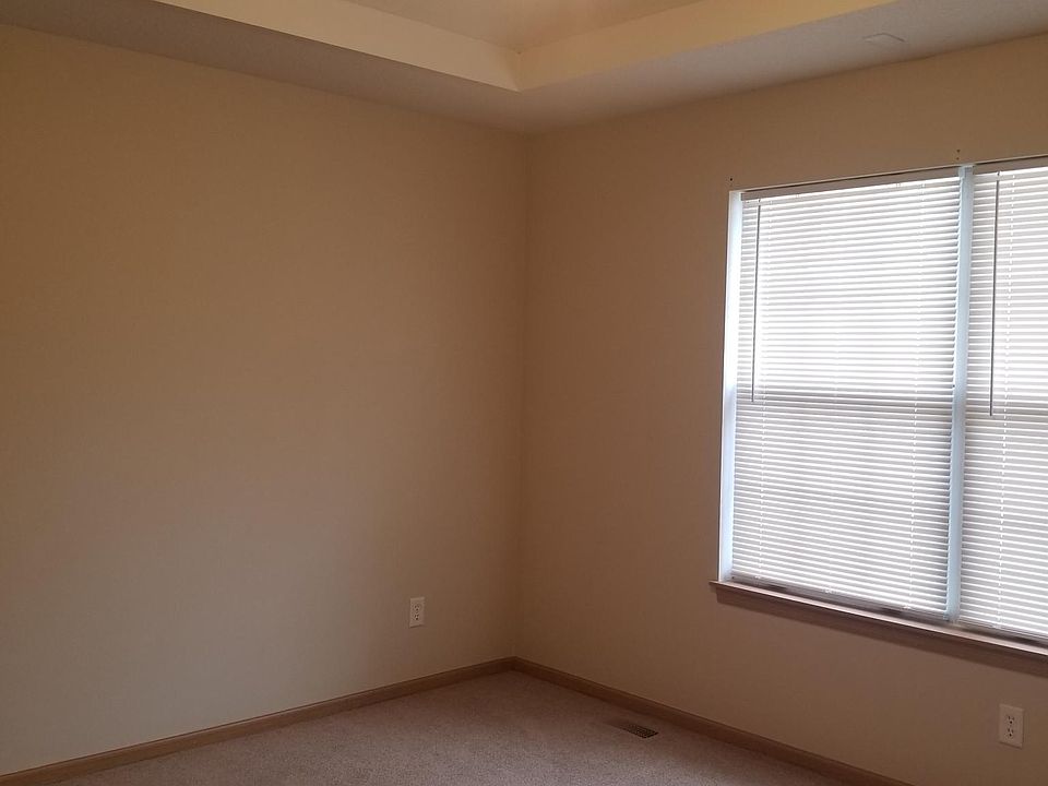 Master bedroom with walk in closet. Vaulted ceiling and ceiling fan