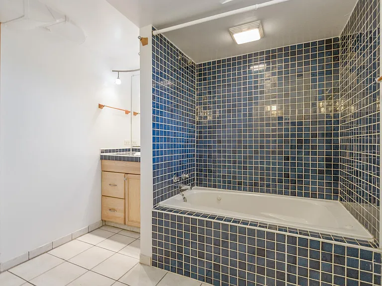 Another view of amazing Italian blue tile surround for this built-in jetted tub + shower.