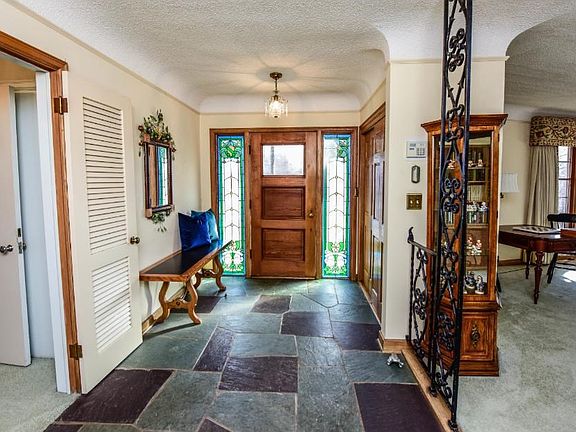 Love this foyer with tile floors and stained glass windows.