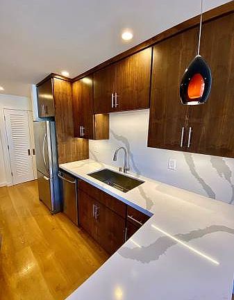 Unit #222 custom kitchen with stunning quartzite countertops! All stainless steel appliances!